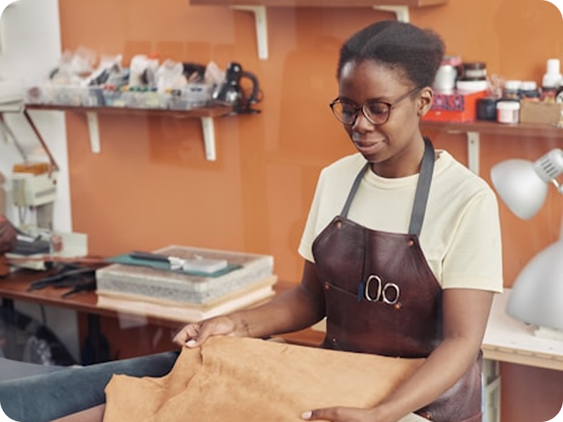 Skilled Nigerian tailor crafting garment